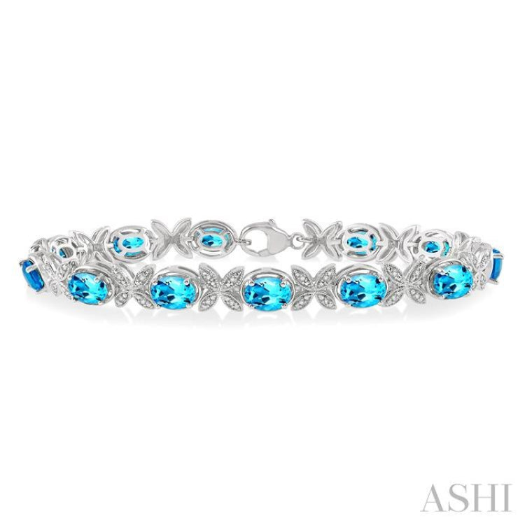 7x5 MM Oval Cut Blue Topaz and 1/10 Ctw Round Cut Diamond Semi-Precious Bracelet in Sterling Silver