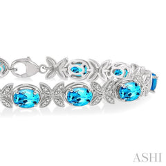 7x5 MM Oval Cut Blue Topaz and 1/10 Ctw Round Cut Diamond Semi-Precious Bracelet in Sterling Silver